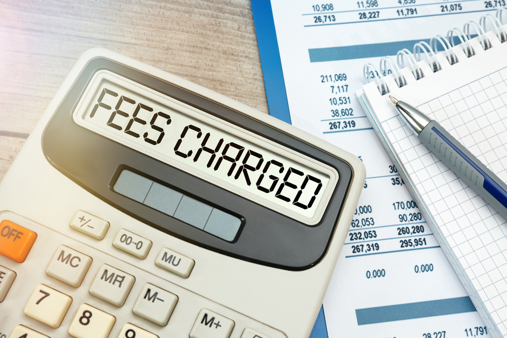 the words FEES CHARGED typed on calculator.